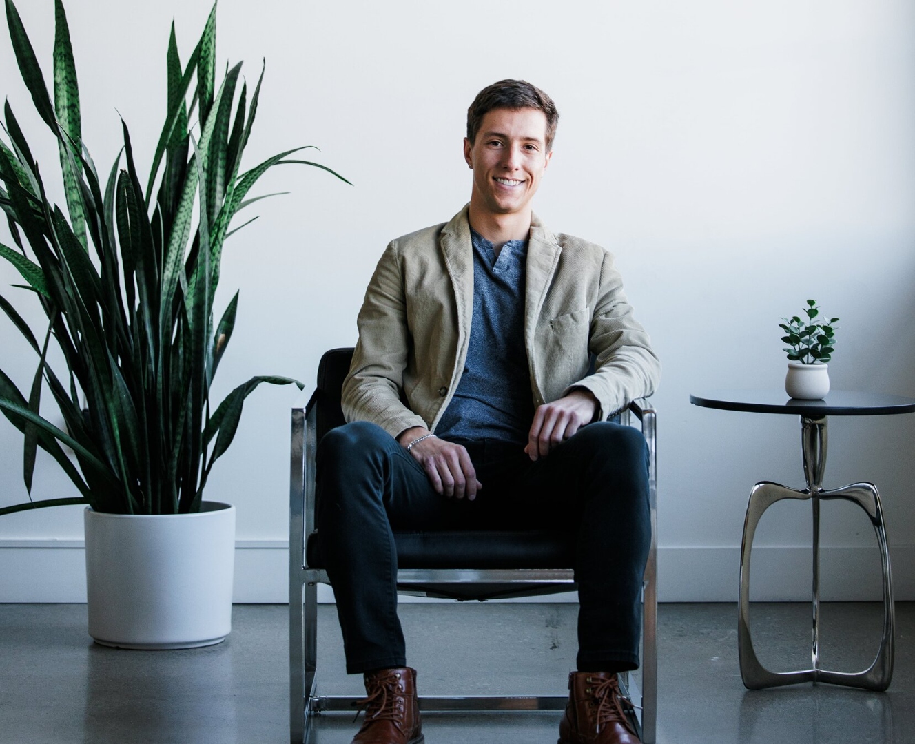 Mark Curry seated confidently in a modern chair